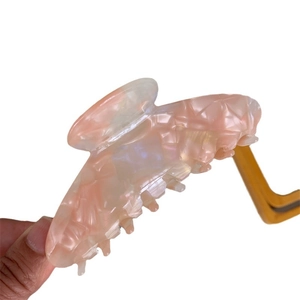Elegant large pink acetate hair claw clip with pearlescent marble texture for women