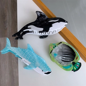 Detail of creative acetate hair claws showing orca and whale shark animal shapes