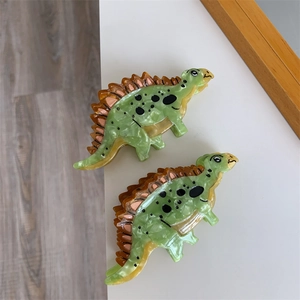 Cartoon dinosaur hair claw clip made of green acetate with unique marble texture patterns