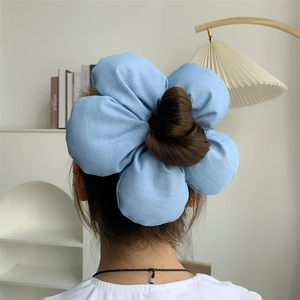 Oversized light blue denim flower scrunchie hair accessory for women on hair bun