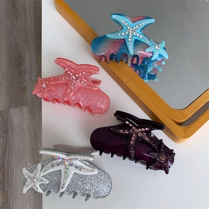 Set of four starfish hair claws with colorful rhinestones in blue, pink, and silver