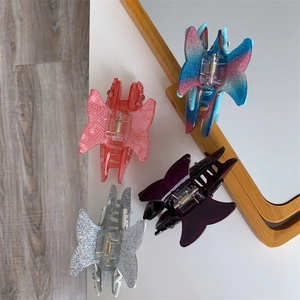 Detail showing set of four acetate butterfly hair claws with rhinestone and glitter finish