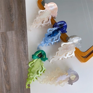 Colorful acetate jellyfish hair claws with pearlescent finish and glitter texture detail