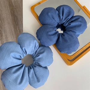 Denim fabric flower hair ties in dark and light blue for stylish bun hairstyles