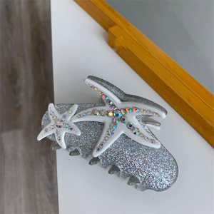 Detail of silver glitter hair claw with crystal starfish and acetate finish decoration