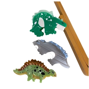 Three dinosaur-shaped acetate hair claws in green and marble grey colors