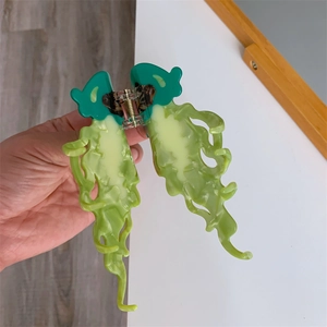 Detail showing high-quality green acetate jellyfish hair claw clip with strong metal spring