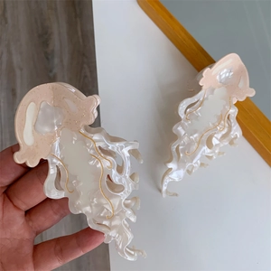 Detailed macro view of pink jellyfish hair claw clip made from colorful acetate fiber