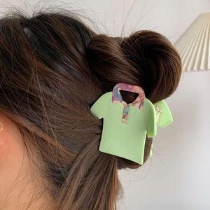 Creative shirt-shaped acetate hair claw clip in light green on a brown hairstyle