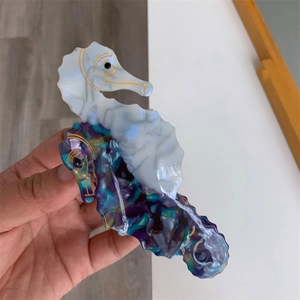 Close-up of seahorse acetate hair claw clip showing creamy and purple marble textures