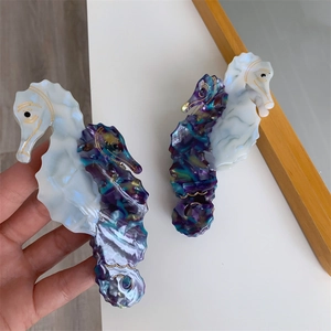 Detailed view of seahorse hair claws made of premium acetate with marble texture
