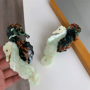 Detail of seahorse acetate hair claws showing marble and tortoiseshell patterns