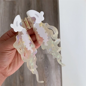 Detail of large jellyfish hair claw clip with iridescent finish and wavy design