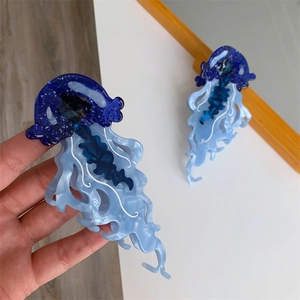 Detailed view of colorful acetate jellyfish hair claw clip with blue glitter details