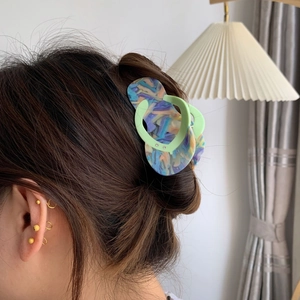 Detail of creative flip-flop shaped acetate hair claw clip with colorful marble texture