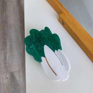 Detailed close-up of a cabbage-shaped acetate hair claw clip with green and white marble textures