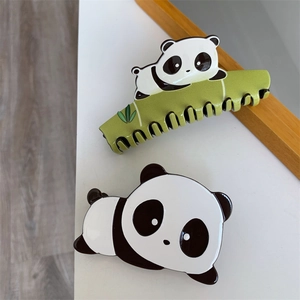 Close-up of cute panda hair clips with green bamboo-shaped claw and acetate panda hairpin