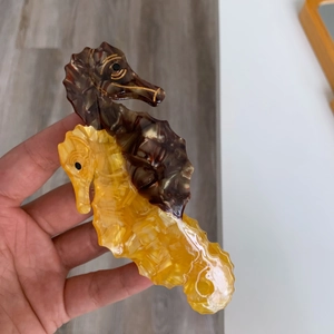 Macro shot of double seahorse claw clip featuring brown and yellow acetate marble textures