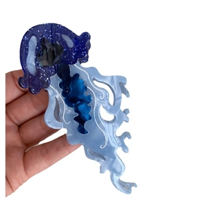 Creative blue jellyfish hair claw clip made of acetate with shimmering marble patterns