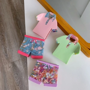 Detailed view of creative polo shirt and shorts shaped acetate hair claws with rhinestones