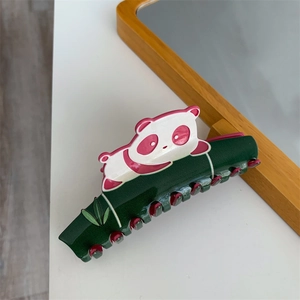 Detailed view of creative panda hair claw clip on green bamboo acetate shark clip
