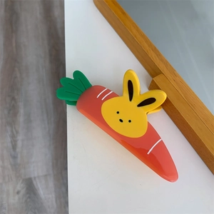 Detail of a carrot and bunny hair claw clip showing smooth resin texture and design