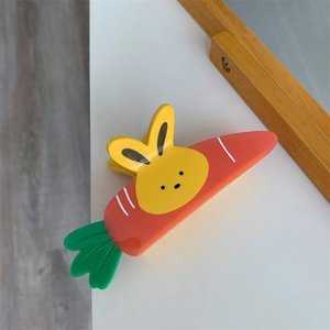 Close-up of a cute carrot and bunny hair claw clip made of polished acetate material