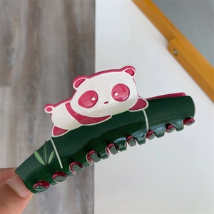 Close-up of a panda and bamboo hair claw clip made of glossy acetate material