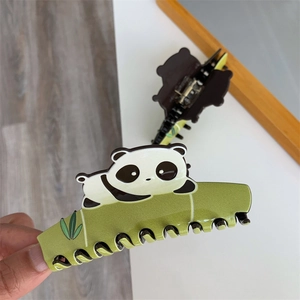 Detail of panda hair claw clip showing acetate green bamboo joint texture and small panda