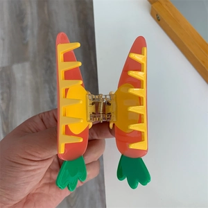 Detail of creative carrot hair claw clip with orange body and sturdy metal spring