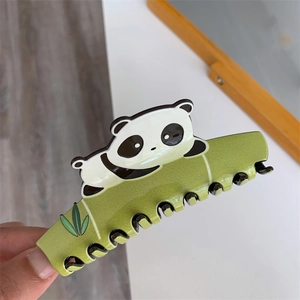 Detailed close-up of a creative panda and green bamboo acetate hair claw clip