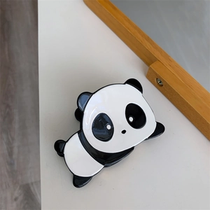 Detailed view of the cute panda hair claw clip with a glossy black and white finish