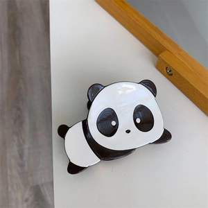 Close-up of cute black and white panda hair claw clip made of glossy acetate material
