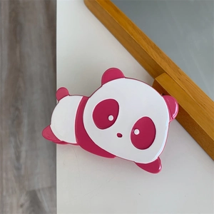 Detailed view of a cute pink and white panda hair claw clip made of glossy acetate material