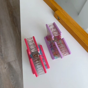 Detail view of pink and purple acetate hair claws with marble texture and metal spring