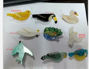 Set of colorful bird-shaped acetate hair claws including parrots and toucan designs