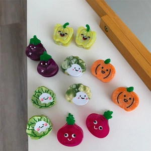 Primer plano de pinzas para el cabello con dibujos de verduras en resina brillante