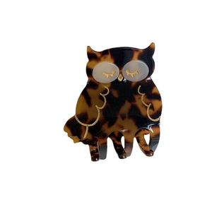 Creative owl-shaped hair claw clip with brown tortoiseshell pattern and golden eyelash details