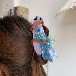 Cicada-shaped acetate hair claw clip with colorful marble texture worn on hair