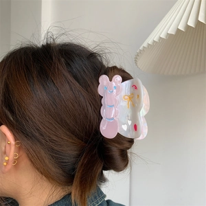 Pinza para el pelo de acetato rosa y blanco con bonitos diseños de conejo y lazo