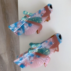 Macro shot of acetic acid grasshopper hair claw clips with colorful marble texture finish