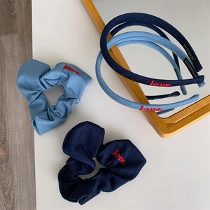 Detail of denim hair accessories with red love embroidery and handmade inner lining