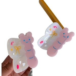 Pinzas para el pelo de acetato tipo mariposa en rosa y blanco con bonitos relieves