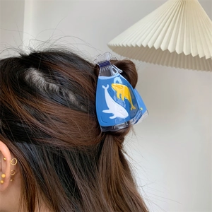 Creative translucent ocean series blue hair claw clip with cute whale design on dark hair