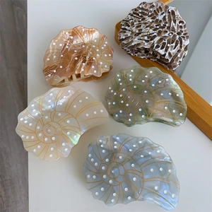 Set of five sea snail acetate hair claws in cream, brown, tortoiseshell, green, and blue