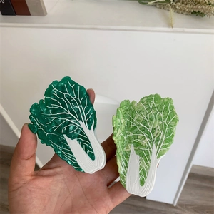 Macro detail of creative green cabbage hair claws showing fine leaf vein textures