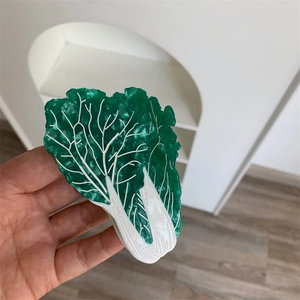 Macro shot of a creative Chinese cabbage hair claw clip made from green marble acetate