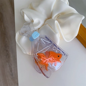 Detail shot of a creative transparent acetate hair claw shaped like a goldfish in a bag