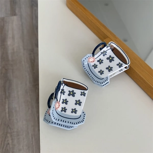 Close-up of floral coffee cup-shaped hair claws in blue and white acrylic finish