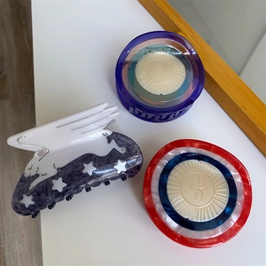 Close-up of acetic acid hair claw clips featuring a white rabbit design and eye motifs